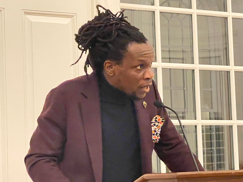 Photo of Ishion Hutchinson, Professor of English at Cornell University, giving a poetry reading at the banquet.