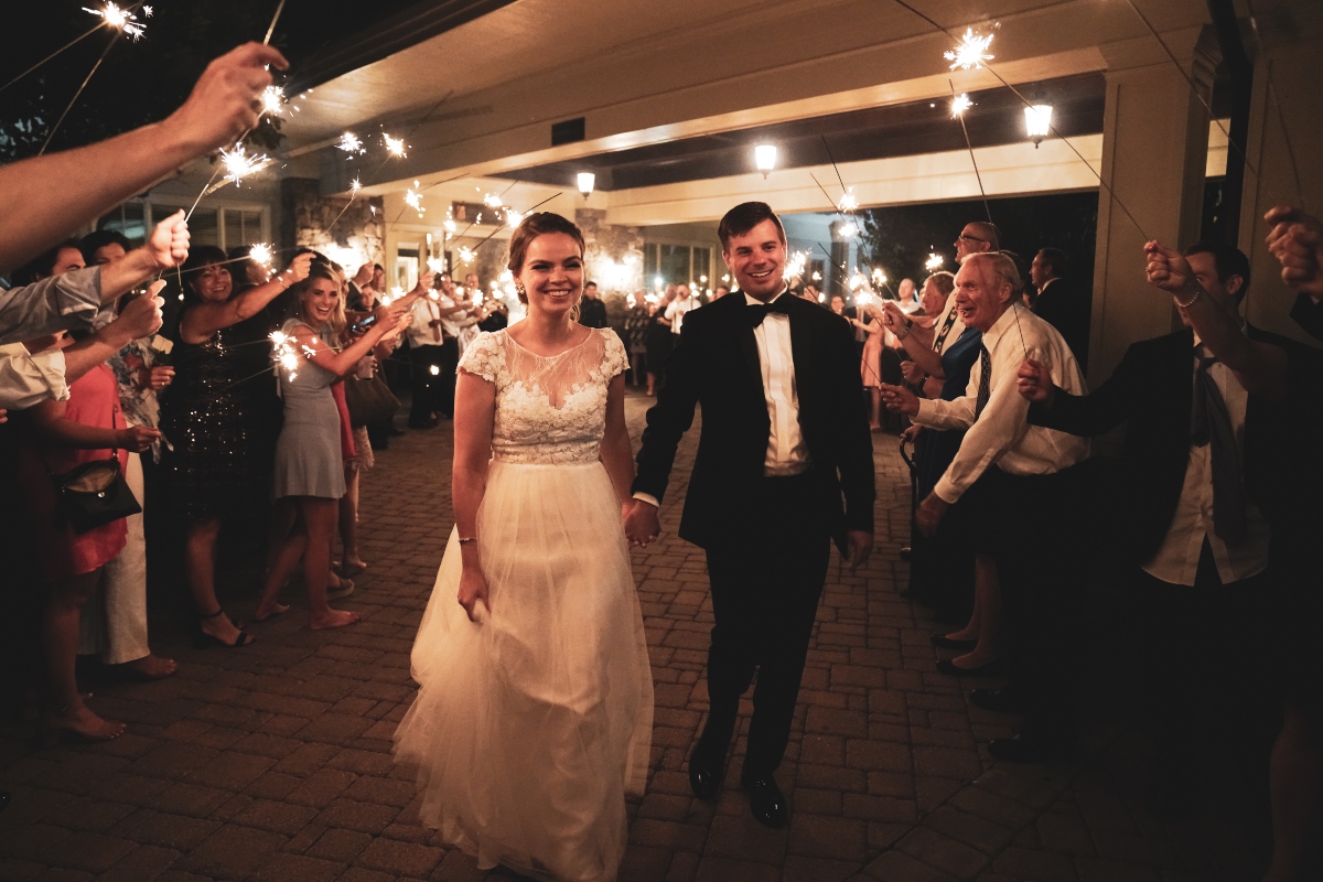 Tyler Lomnizer and his wife Emily leaving their wedding reception
