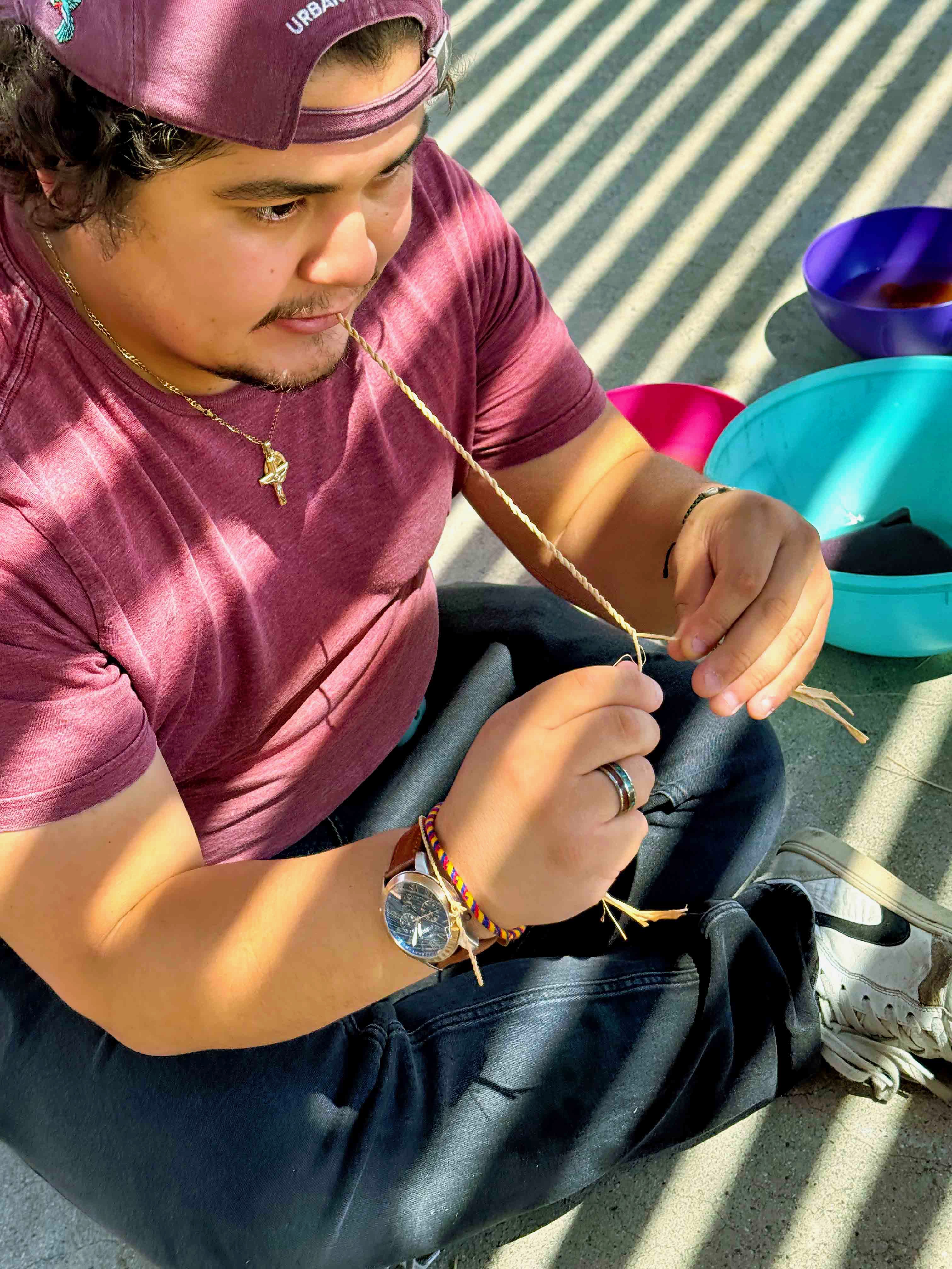 Sam teaching youth how to create Cordage out of Rafia